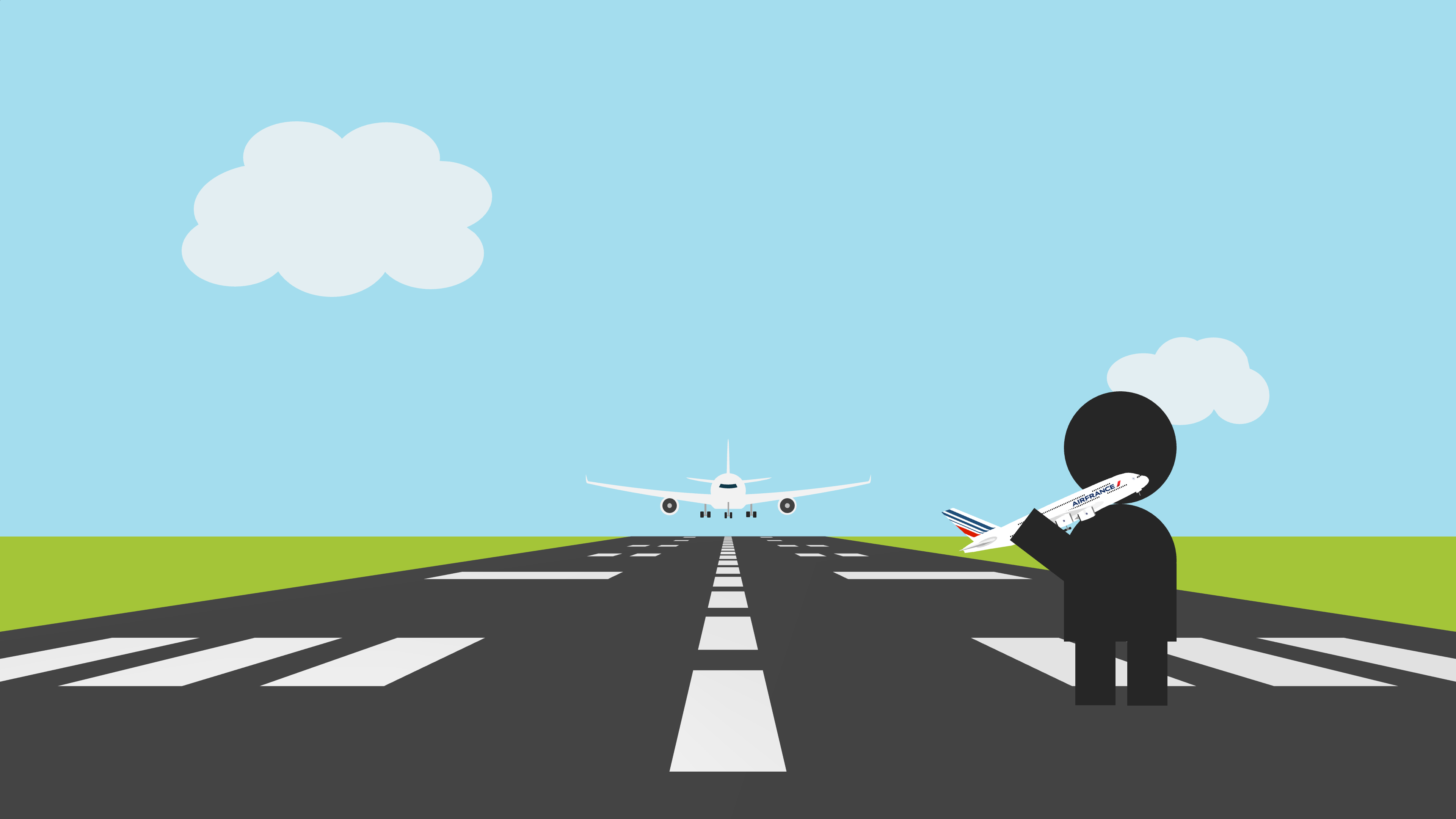 A person holds a model aeroplane while standing on a runway. A descending plane can be seen in the distance.
